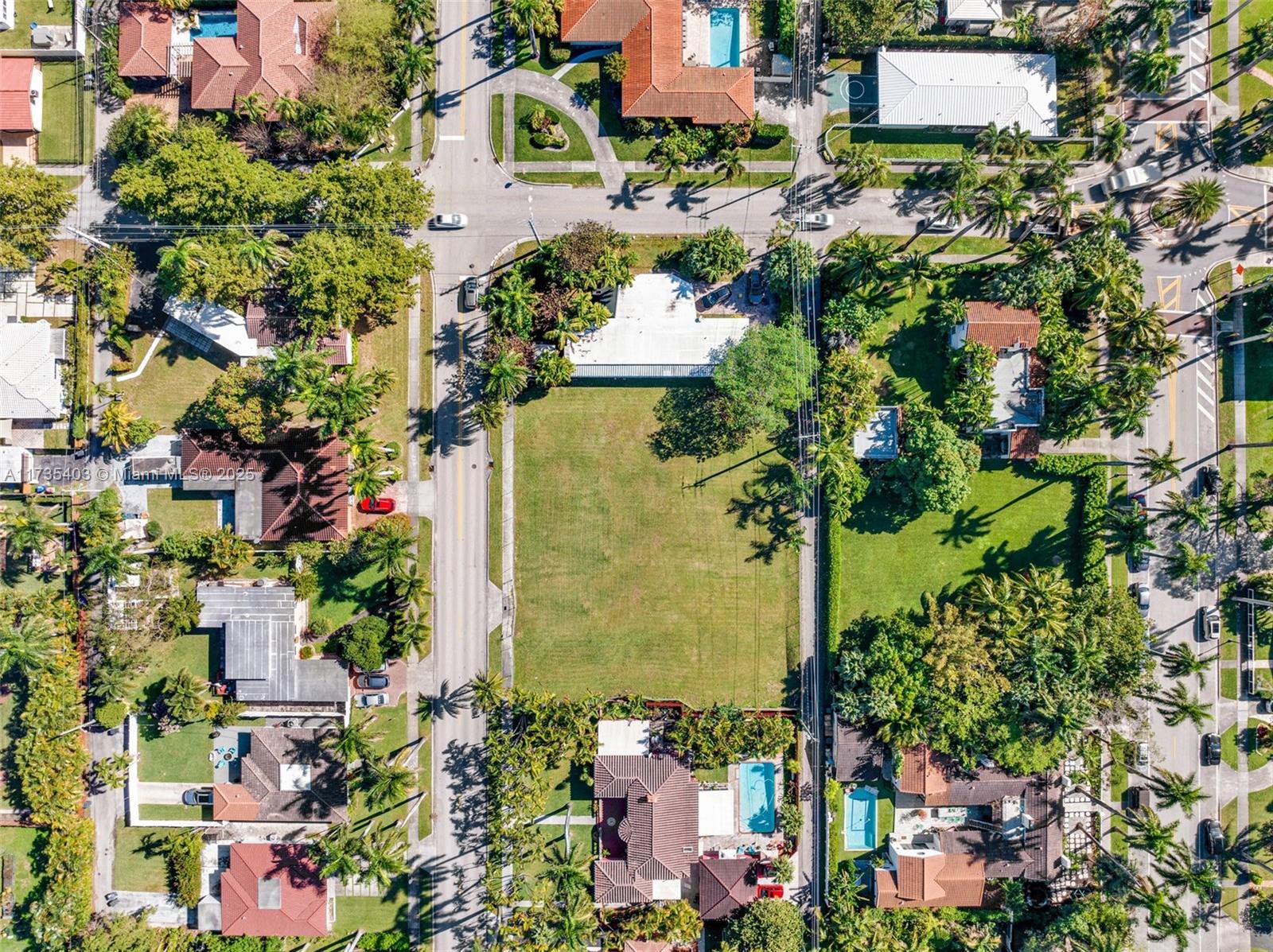 An aerial view shows a large vacant rectangular lot surrounded by residential houses and streets — 1312 Polk St, Hollywood FL 33019, HOLLYWOOD, FL