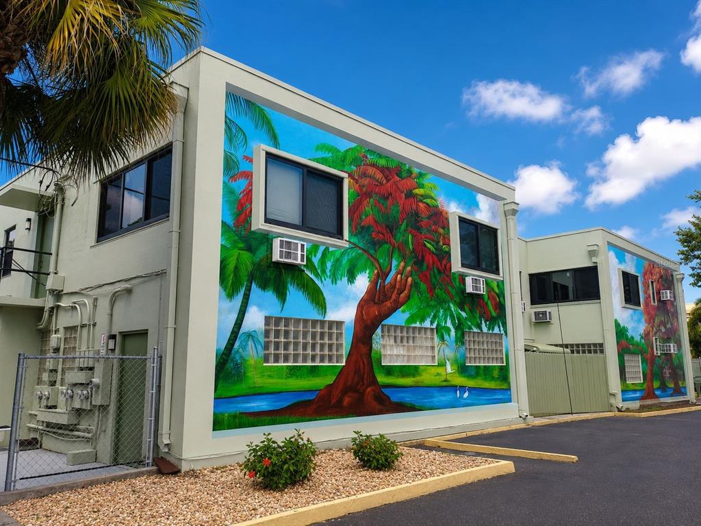 Exterior view of a two-story building featuring a large, colorful mural of a tree — 117 N 5TH STREET, FORT PIERCE, FL