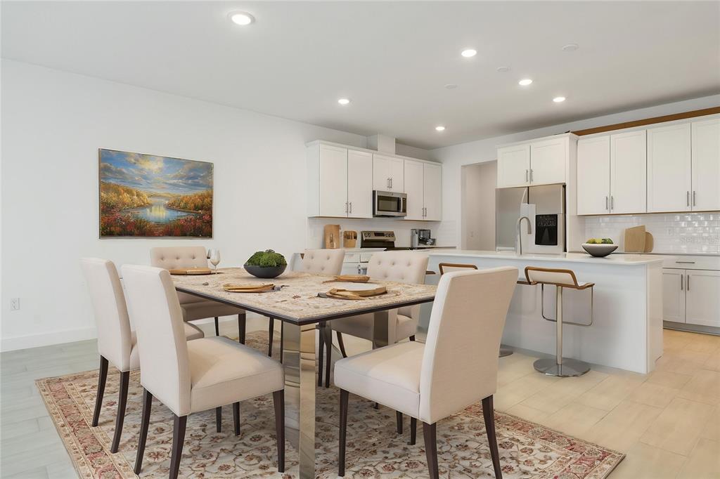 A dining area with a stone-topped table and upholstered chairs sits beside a white kitchen — 9093 PLAYERS DRIVE, WEEKI WACHEE, FL