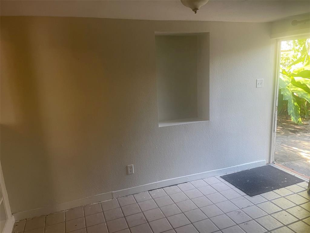 An interior room with tiled flooring, a recessed wall niche, and a doorway leading outside — 776 27TH AVENUE N UNIT 2, ST PETERSBURG, FL