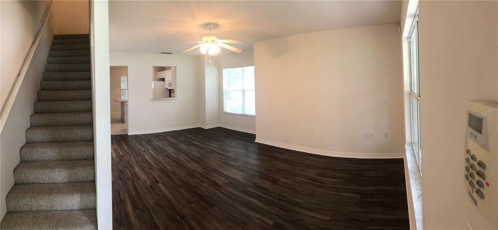 A multi-story townhouse exterior features tan siding, white columns, and dark brown front doors — 2375 SW 42ND WAY UNIT 160, GAINESVILLE, FL