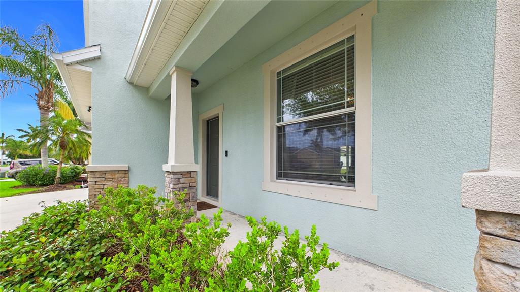 A light blue house exterior features a covered entryway, a window, and stone-accented columns — 601 19TH STREET NW, RUSKIN, FL