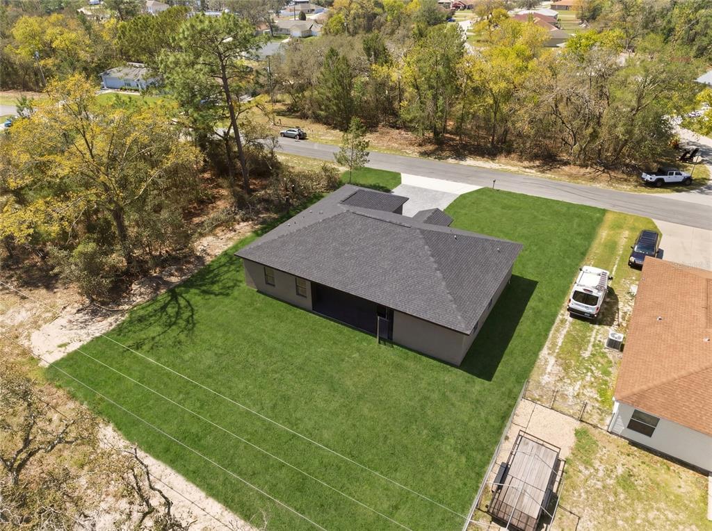 An aerial view of a single-story house with a large backyard and a paved driveway — 14919 SW 46TH CIRCLE, OCALA, FL