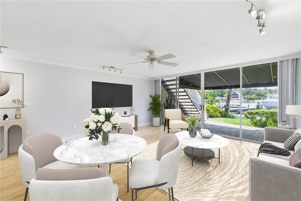 This living and dining area features a marble table, neutral furniture, and sliding glass doors — 2424 W TAMPA BAY BOULEVARD UNIT G104, TAMPA, FL