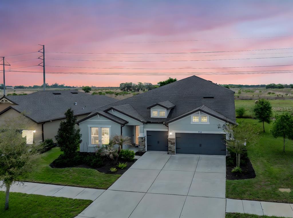 An aerial view of a single-story suburban house with a gray garage and driveway — 11701 BRIGHTON KNOLL LOOP, RIVERVIEW, FL