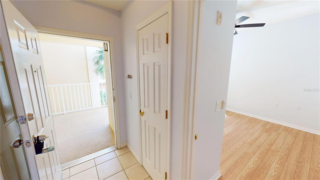 An entryway with tile flooring leads to an open door, a closet, and a bedroom — 255 W END DRIVE UNIT 3206, PUNTA GORDA, FL