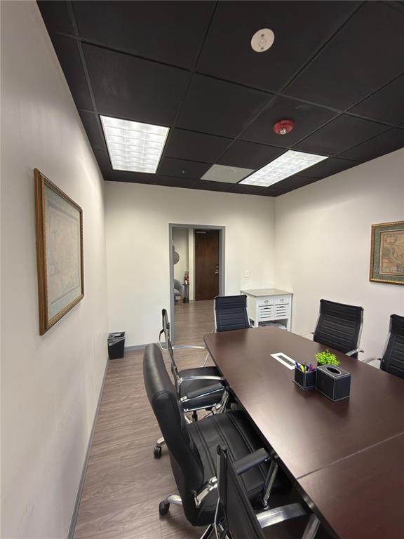 A conference room features a dark wood table, black chairs, and a black drop ceiling — 6735 CONROY ROAD UNIT 201, 203, ORLANDO, FL