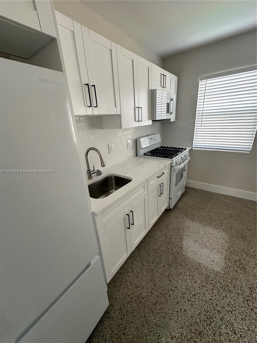 A kitchen features white shaker cabinets, a stainless steel sink, and a gas range — 211 SW 18th Ave # 2, Miami FL 33135, MIAMI, FL
