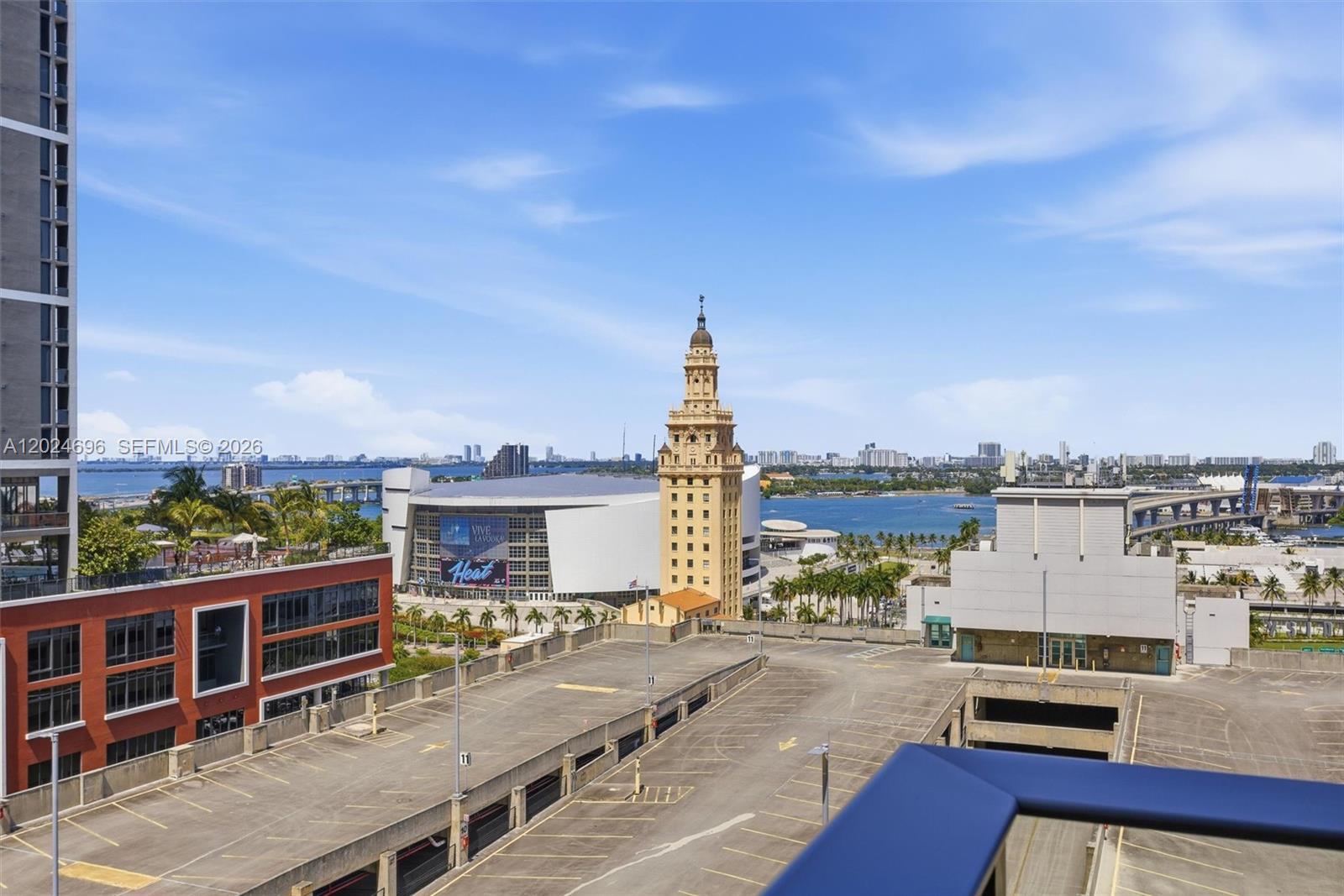 An elevated view shows a parking garage, the Freedom Tower, and the Miami waterfront — 121 NE 5th St # 1712, Miami FL 33132, MIAMI, FL