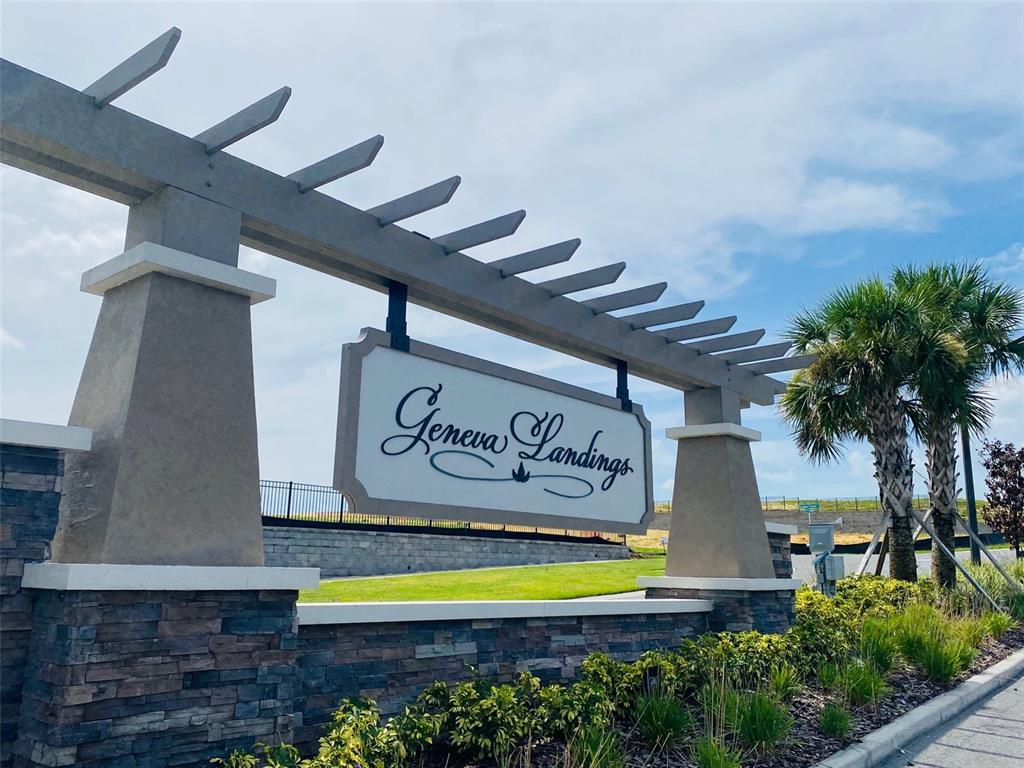 A stone and stucco monument sign for Geneva Landings stands under a wooden pergola — 2486 MATTERHORN TRAIL, DAVENPORT, FL