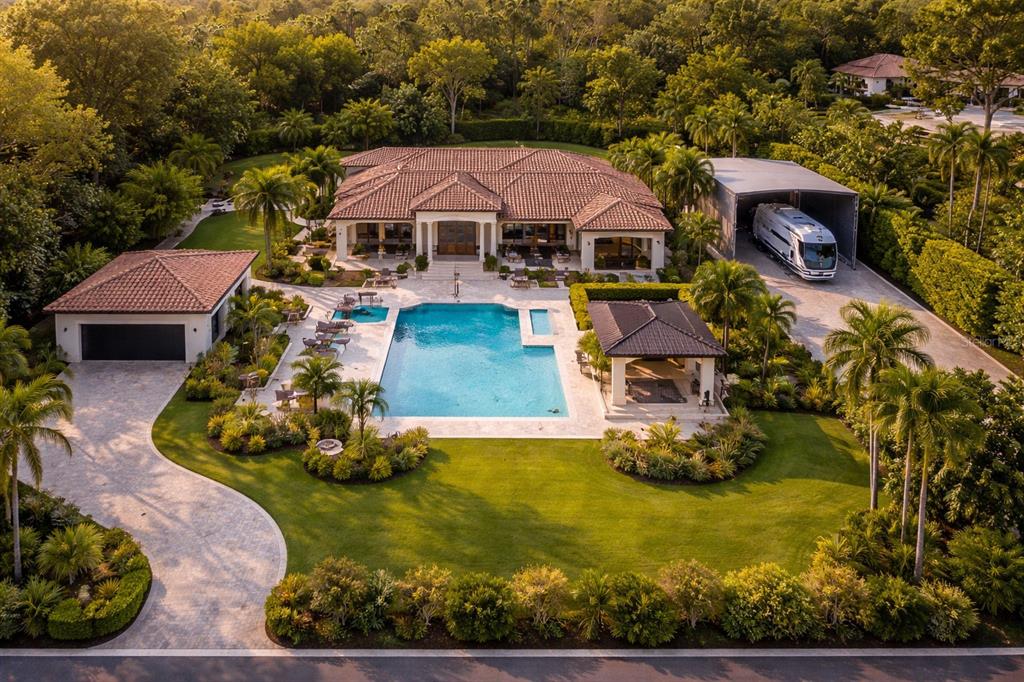 An aerial view of a house with a pool, a detached garage, and an RV port — 2424 ASHTON ROAD, SARASOTA, FL