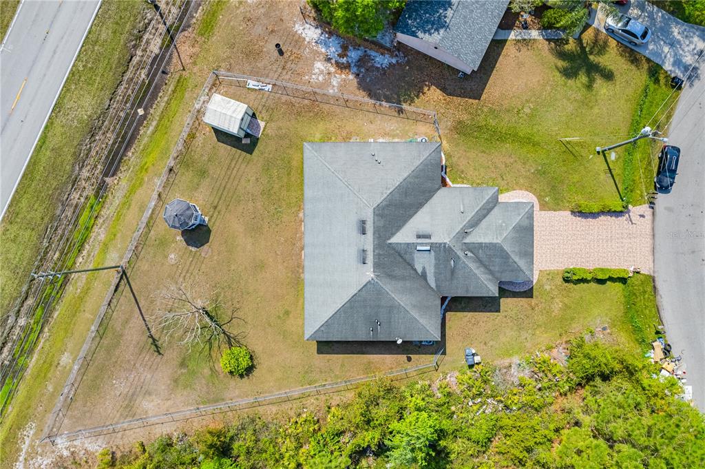 An aerial view shows a house with a gray roof, a shed, and a gazebo — 746-748 MINK CT, POINCIANA, FL