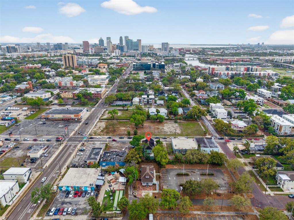 An aerial view shows a house marked with a pin in a dense urban area — 105 W COLUMBUS DRIVE, TAMPA, FL