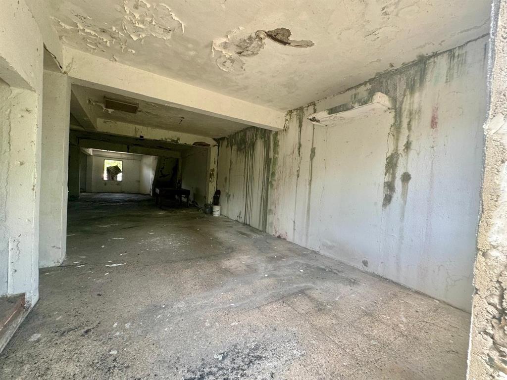 An interior view of a dilapidated, unfinished room with water-stained walls and a concrete floor — 51 AVENIDA TROCHE, CAGUAS, PR