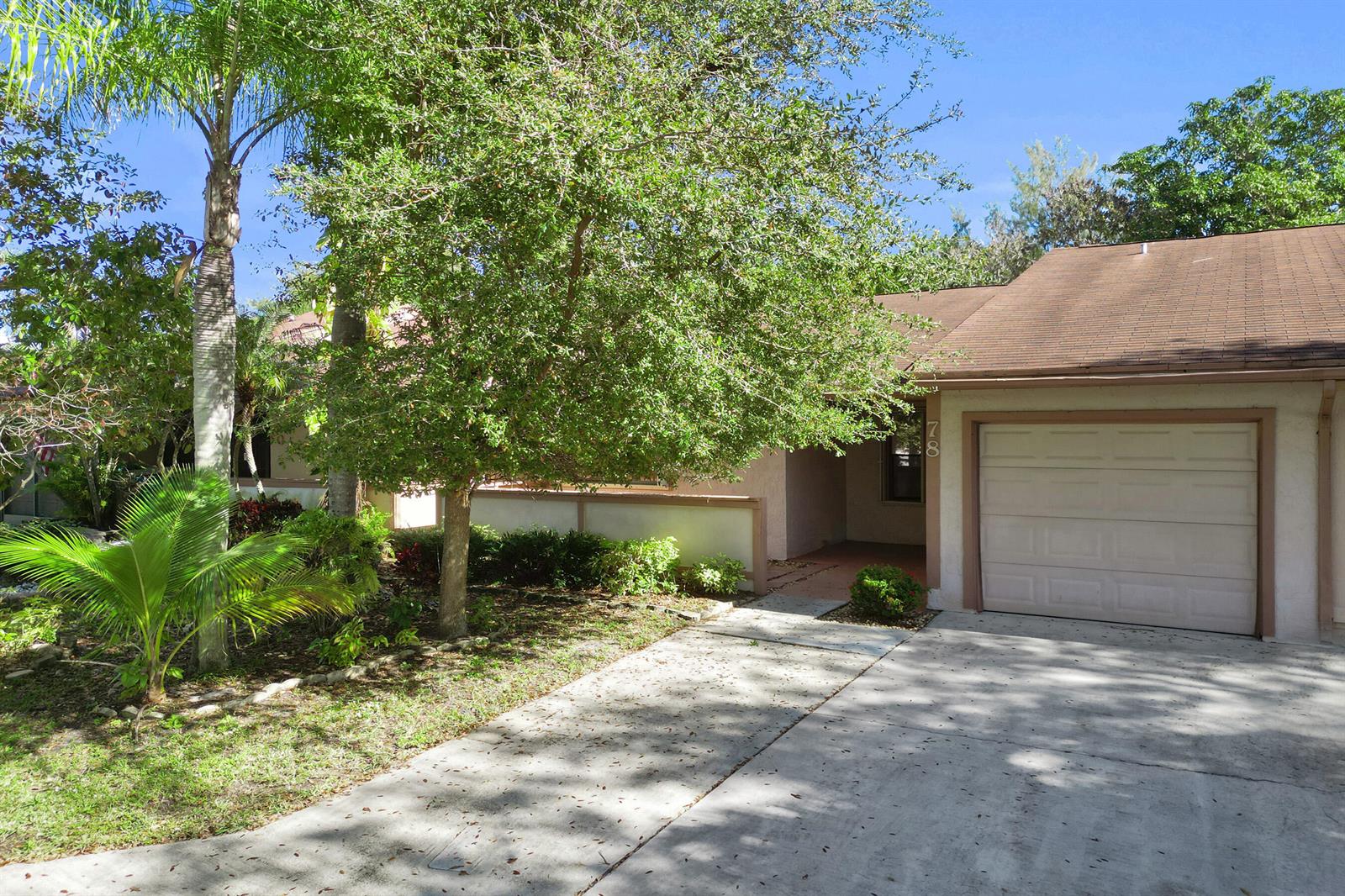 A single-story house with a concrete driveway, a one-car garage, and a large shade tree — 78 Mayfair Lane # 78, Boynton Beach FL 33426, BOYNTON BEACH, FL