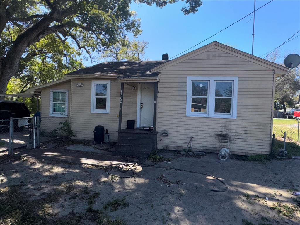 A single-story house with light-colored siding, a front porch, and a dirt yard — 1500 43RD STREET, ORLANDO, FL