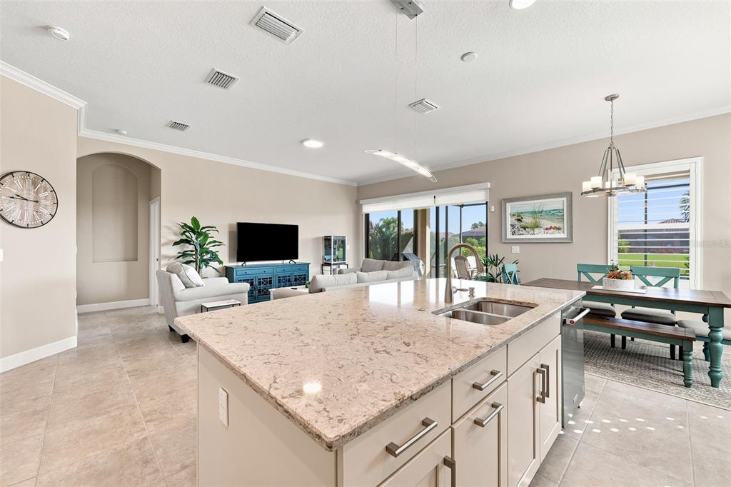 A screened-in patio features brick pavers, outdoor furniture, and a view of a pond — 4616 STICKLEY COURT, PALMETTO, FL