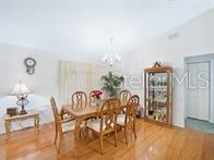 A dining room features a wooden table with six chairs, a china cabinet, and hardwood floors — 5045 NW 32ND PLACE, OCALA, FL