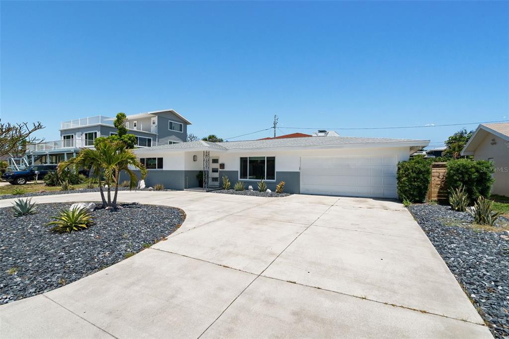 A single-story house with a white and gray exterior, a two-car garage, and a driveway — 2671 W BAY ISLE DRIVE SE, ST PETERSBURG, FL