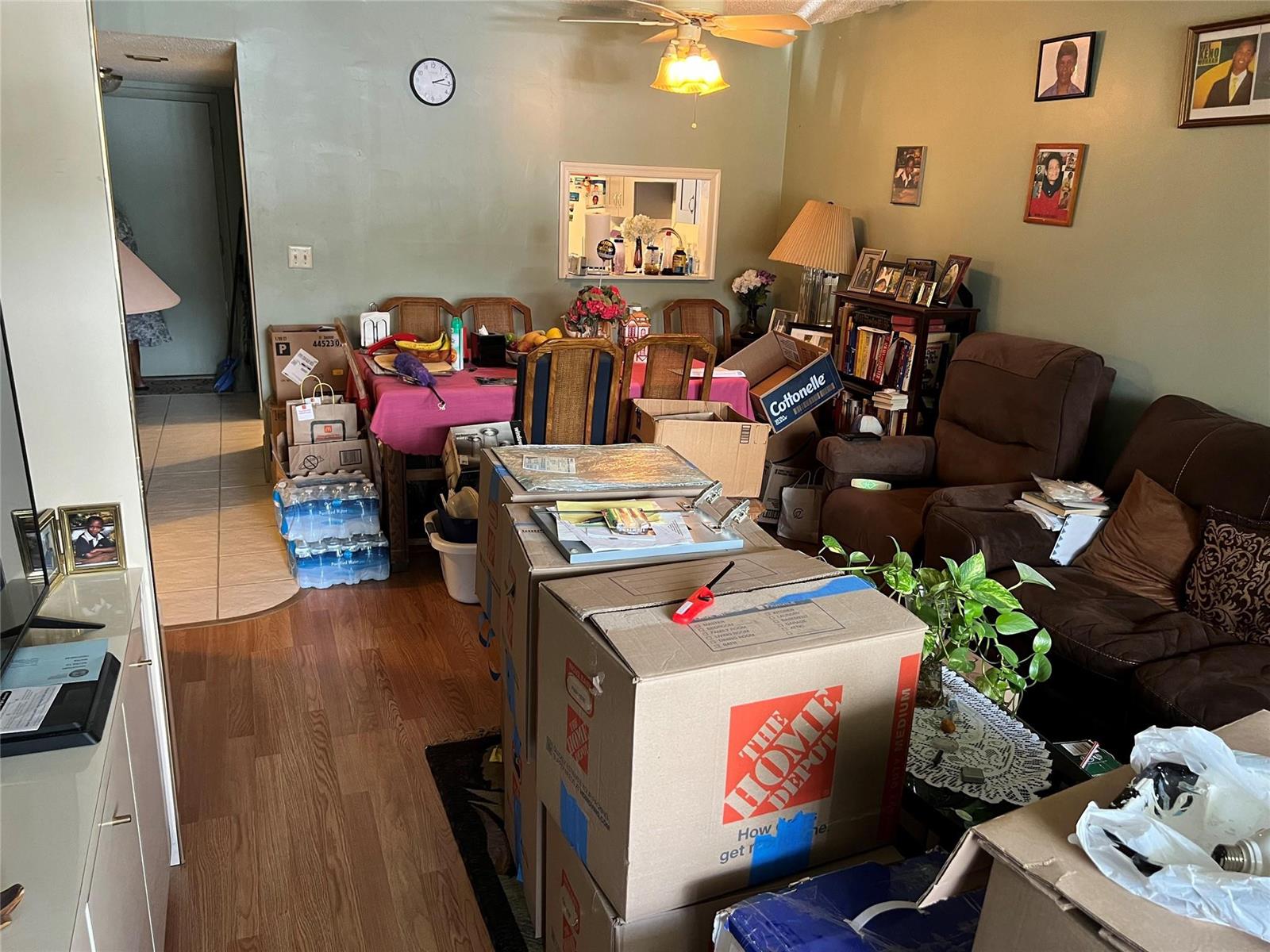 A living and dining area filled with numerous cardboard moving boxes and household items — 3140 Holiday Springs Boulevard # 109, Margate FL 33063, MARGATE, FL