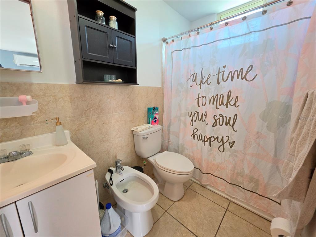 A bathroom features a vanity, a toilet, a bidet, and a shower with a curtain — 838 IMPERIAL, JUANA DIAZ, PR