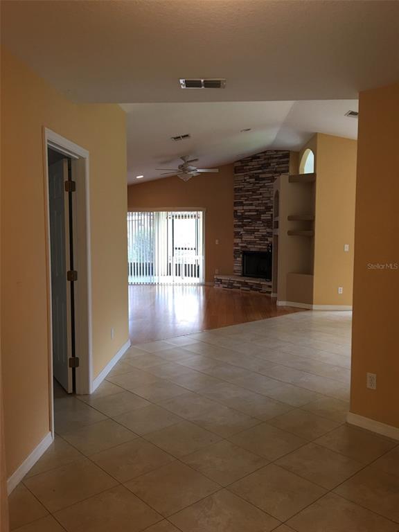 A tiled entryway leads to a dark wood front door under a vaulted ceiling — 635 NIGHTHAWK CIRCLE, WINTER SPRINGS, FL