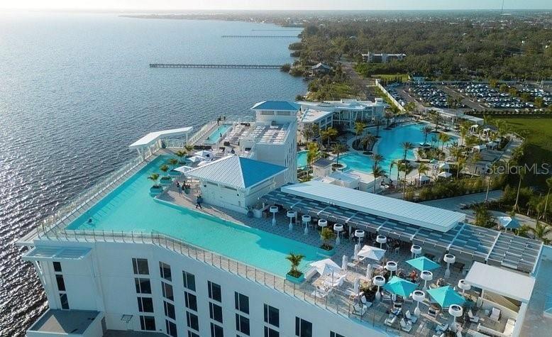 An aerial view of a hotel featuring a rooftop infinity pool and a ground-level pool — 2250 SULSTONE DRIVE, PUNTA GORDA, FL