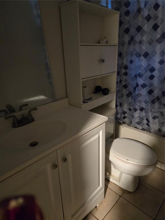 A bathroom featuring a white vanity, a tall storage unit, and a toilet — 572 MAINELINE BOULEVARD, APOPKA, FL