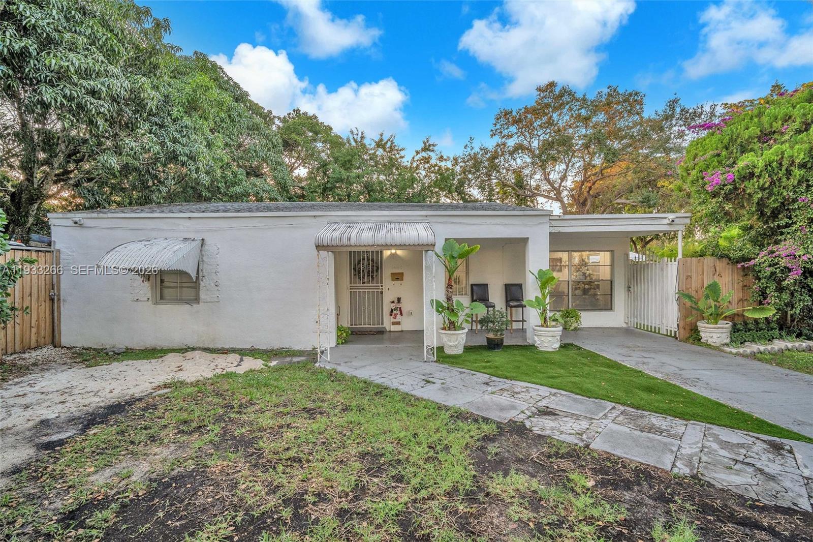 A single-story white house features a front porch, a carport, and a small lawn — 14140 NE 10th Ave, North Miami FL 33161, NORTH MIAMI, FL