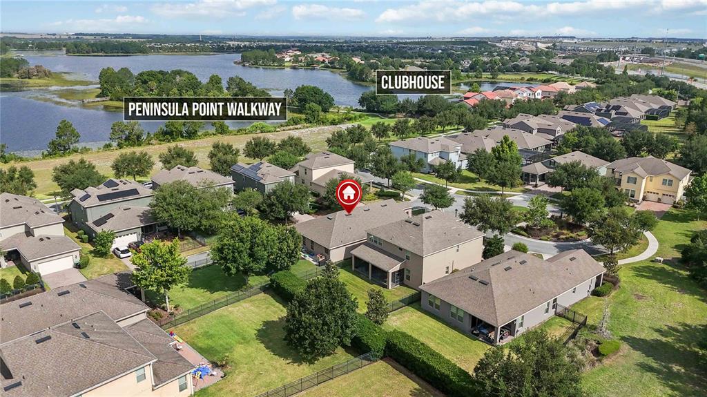 An aerial view shows a suburban neighborhood with houses, a lake, and a clubhouse — 15518 FOUNTAIN COVE COURT, WINTER GARDEN, FL