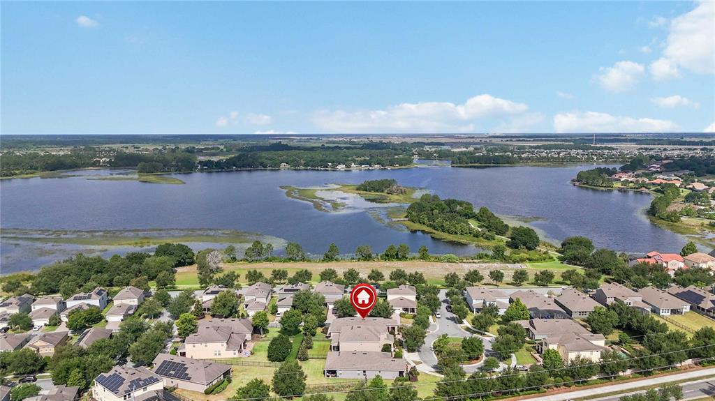 An aerial view shows a suburban neighborhood situated along the edge of a large lake — 15518 FOUNTAIN COVE COURT, WINTER GARDEN, FL