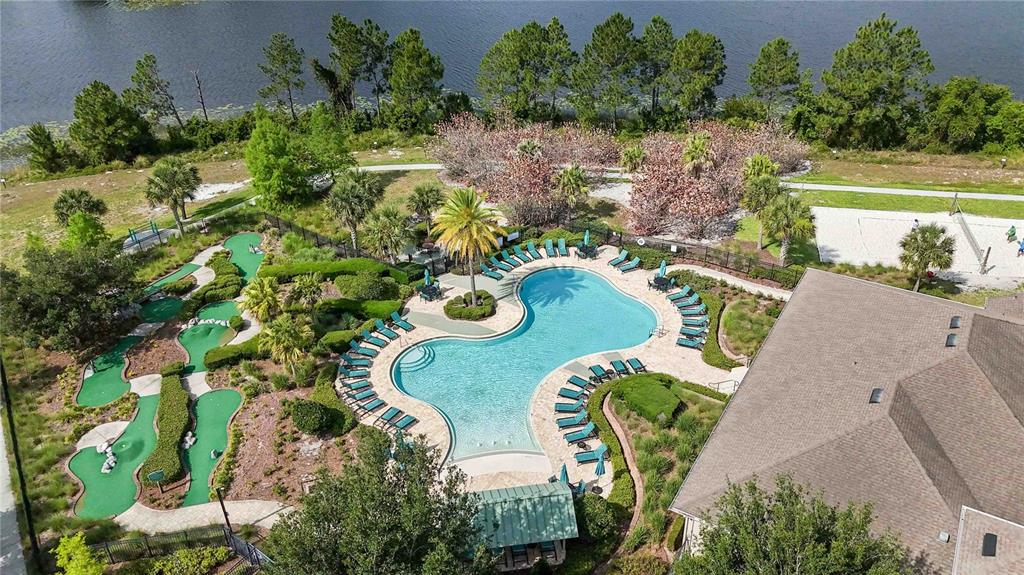 An aerial view shows a swimming pool, a miniature golf course, and a building near water — 15518 FOUNTAIN COVE COURT, WINTER GARDEN, FL