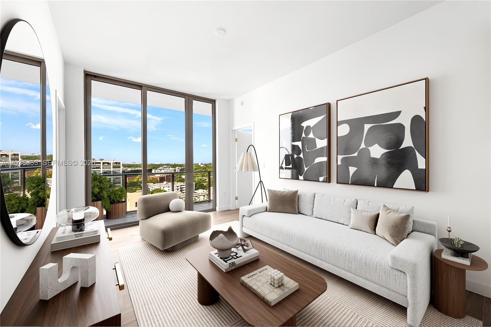A modern living room features a white sofa, a wooden coffee table, and floor-to-ceiling windows — 2678 Tigertail Ave # 1005, Miami FL 33133, MIAMI, FL