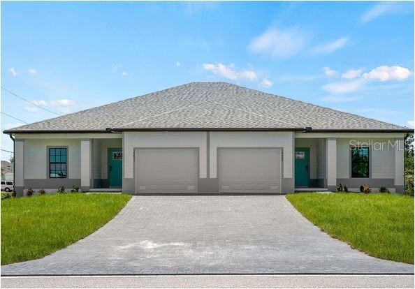 A duplex house with two garage doors and two teal front doors under a hip roof — 14449 & 14451 APPLETON BOULEVARD, PORT CHARLOTTE, FL