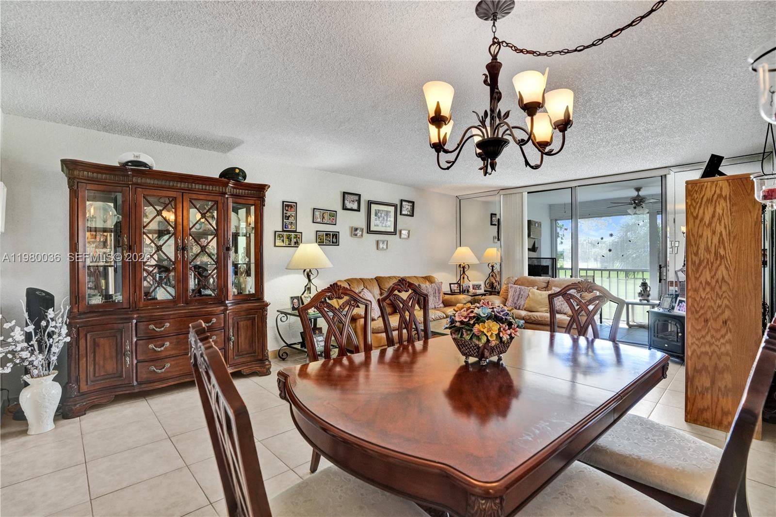 A dining area with a wooden table and hutch opens into a living room space — 7400 NW 18th St # 204, Margate FL 33063, MARGATE, FL