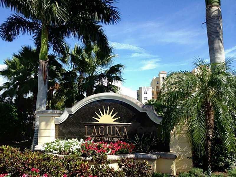 A sign for Laguna at Riviera Dunes stands in front of palm trees and buildings — 611 RIVIERA DUNES WAY UNIT 604, PALMETTO, FL