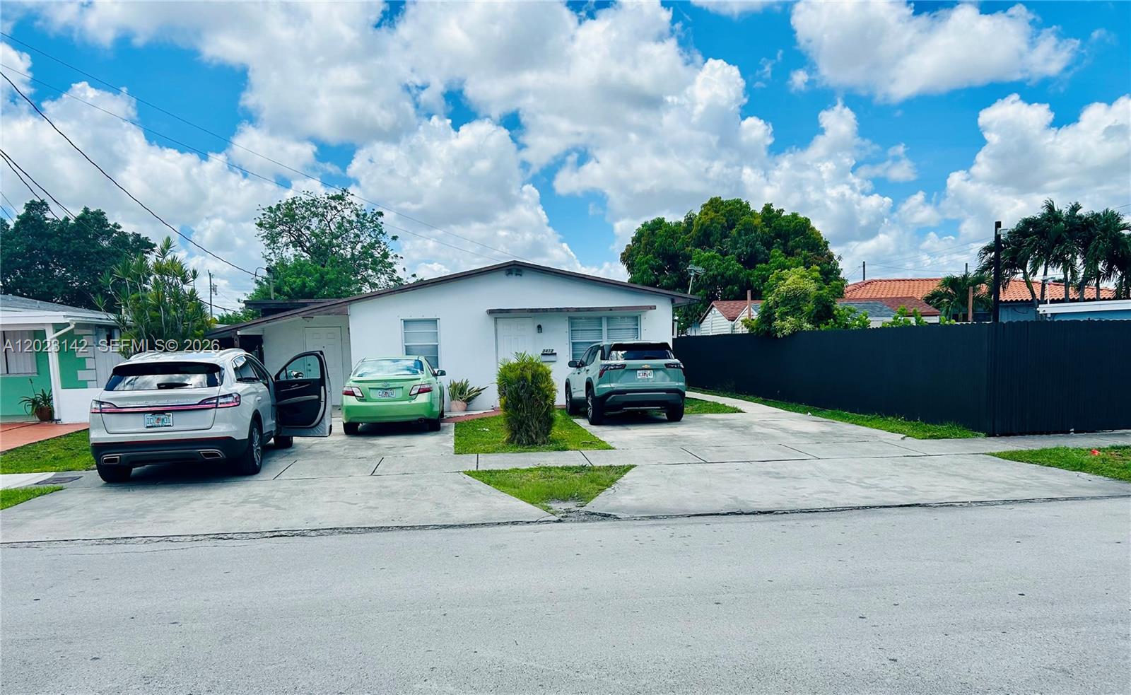 A single-story white house features a concrete driveway with three parked cars — 3410 SW 89th Ct, Miami FL 33165, MIAMI, FL