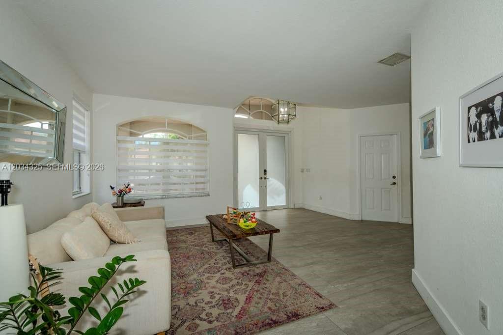 A living room features a white sofa, a patterned rug, and a wooden coffee table — 8526 NW 110th Pl # 0, Doral FL 33178, DORAL, FL