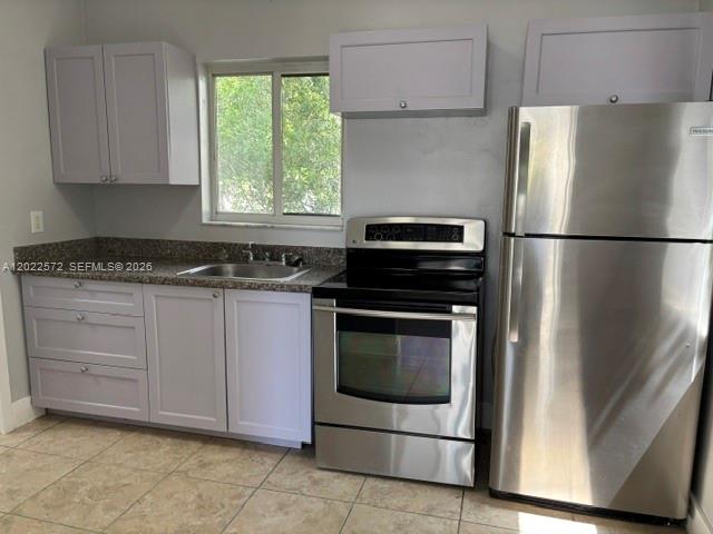 A kitchen features light gray cabinets, stainless steel appliances, and a window above the sink — 2059 SW 7th St # 0, Miami FL 33135, MIAMI, FL