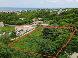 An aerial view shows a vacant, rectangular plot of land outlined in red near houses — 1 HARBOURLIGHTS ESTATES EXTENSION UNIT 52, HUMACAO, PR
