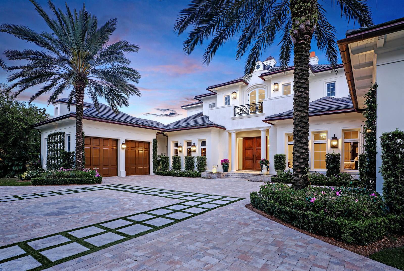 A large white two-story house with a paved driveway, palm trees, and a three-car garage — 131 W Bears Club Drive, Jupiter FL 33477, JUPITER, FL