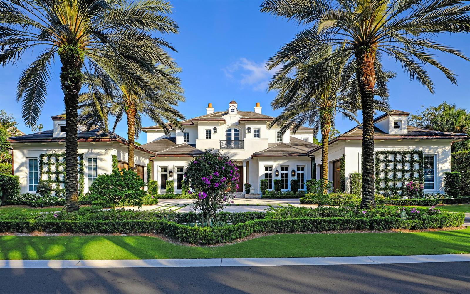 A large white two-story house with a tile roof, palm trees, and manicured landscaping — 131 W Bears Club Drive, Jupiter FL 33477, JUPITER, FL