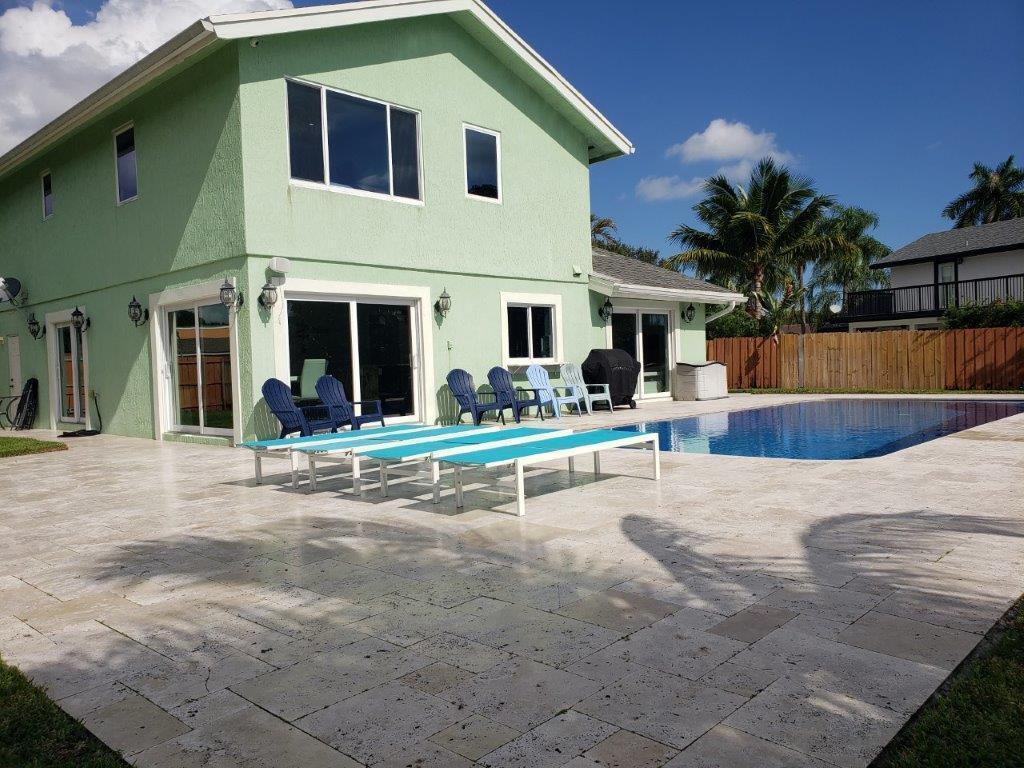 A two-story light green house with a patio, swimming pool, and lounge chairs — 801 NW 49th Way, Coconut Creek FL 33063, COCONUT CREEK, FL