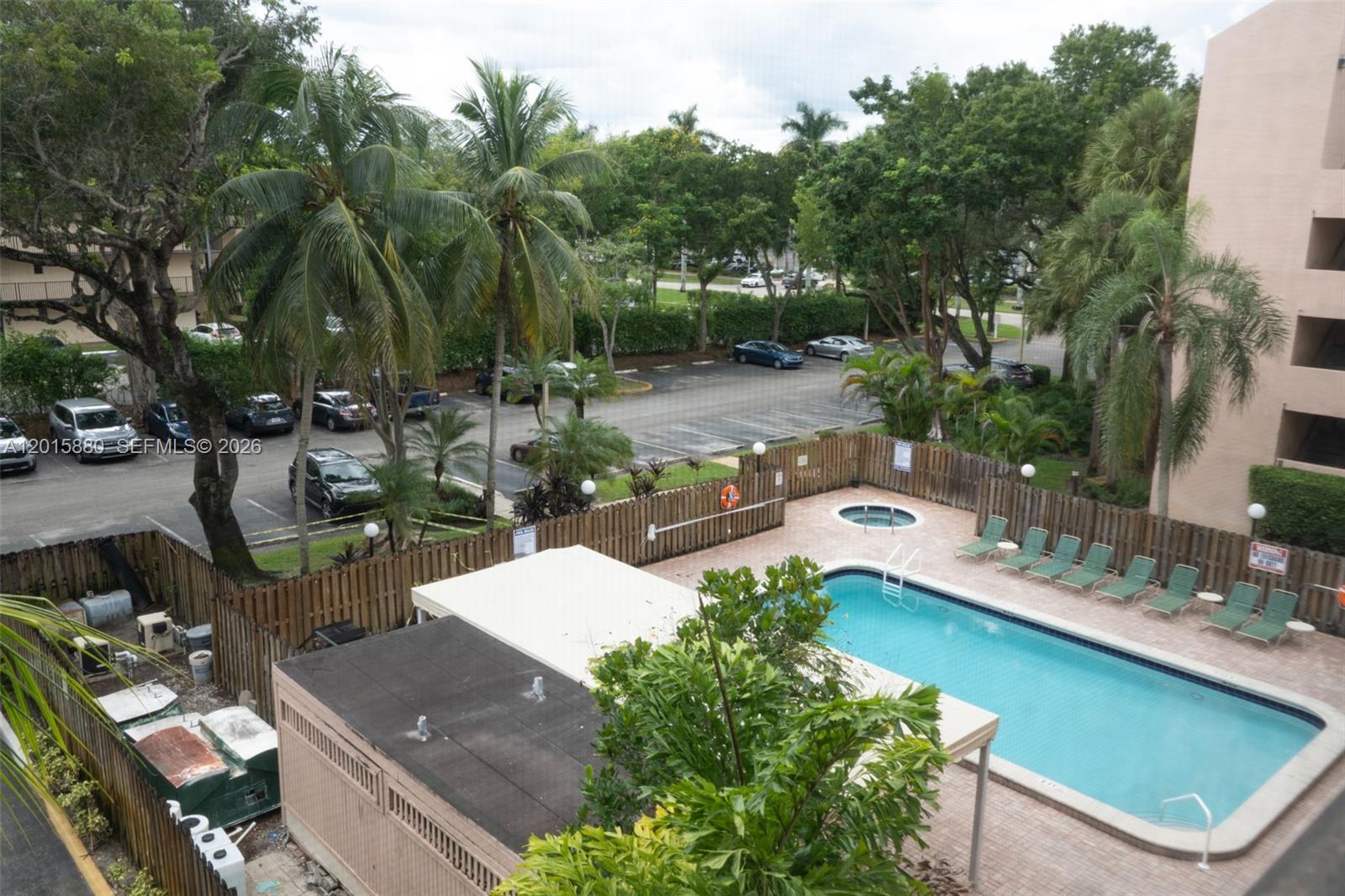 An elevated view shows a swimming pool, a hot tub, and a parking lot — 6800 Cypress Rd # 415, Plantation FL 33317, PLANTATION, FL