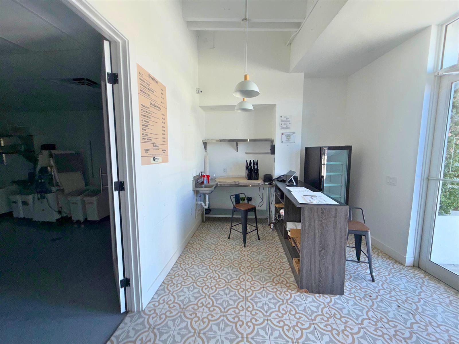 A small commercial space features patterned tile flooring, a service counter, and a menu board — 5505 S Dixie Highway # 4, West Palm Beach FL 33405, WEST PALM BEACH, FL