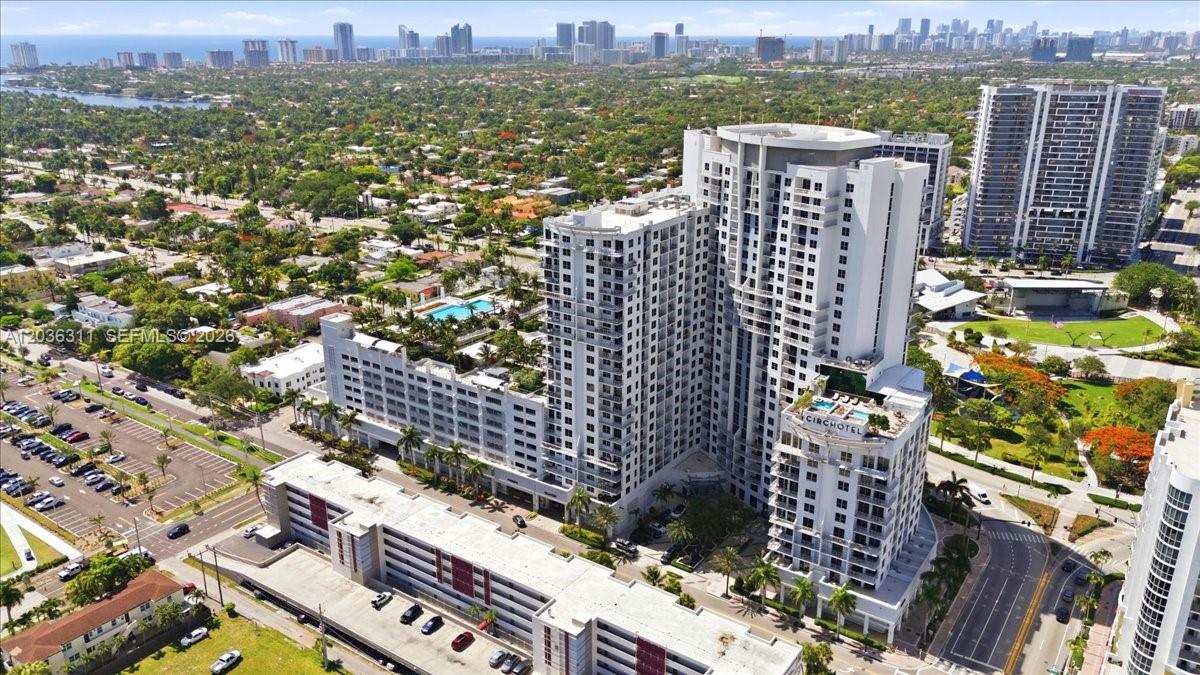 An aerial view of a large multi-story hotel complex with an attached parking garage — 1776 Polk St # 703, Hollywood FL 33020, HOLLYWOOD, FL