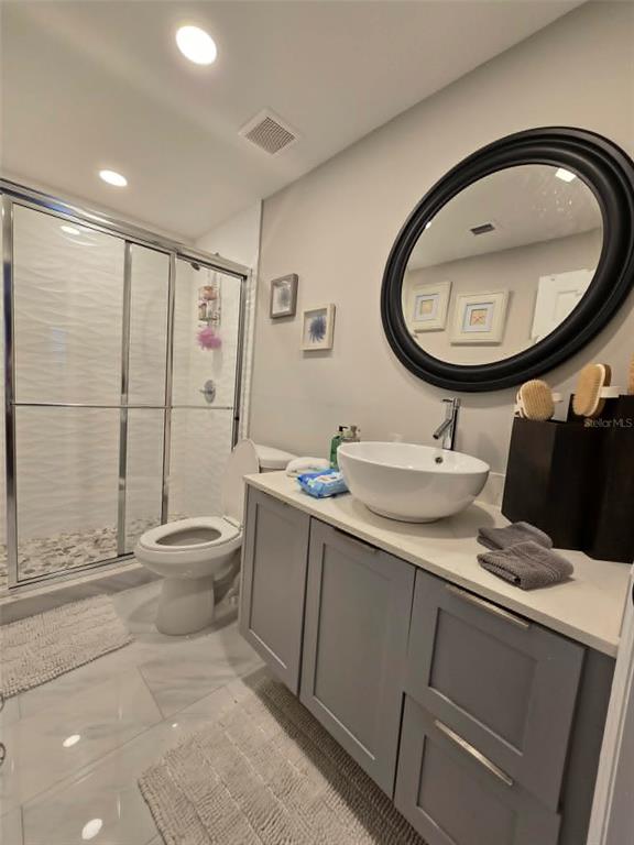 A bathroom features a gray vanity with a vessel sink, a walk-in shower, and tile flooring — 244 LEXINGTON DRIVE, DAYTONA BEACH, FL