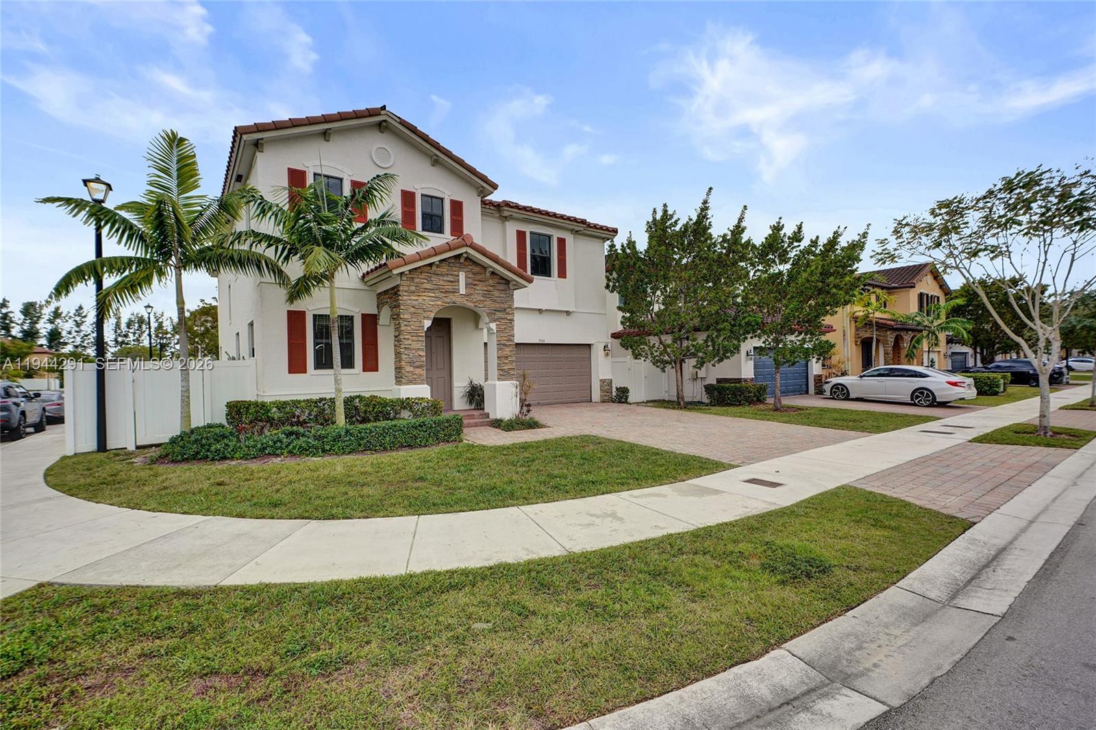 A two-story house with a stone-accented entryway, red shutters, and a paved driveway — 3504 W 94th St, Hialeah FL 33018, HIALEAH, FL