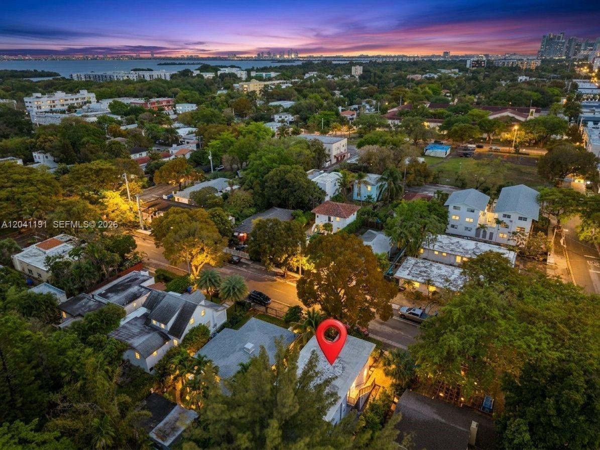 An aerial view shows a residential neighborhood at sunset with a red pin marking a house — 435 NE 69th St # 1, Miami FL 33138, MIAMI, FL