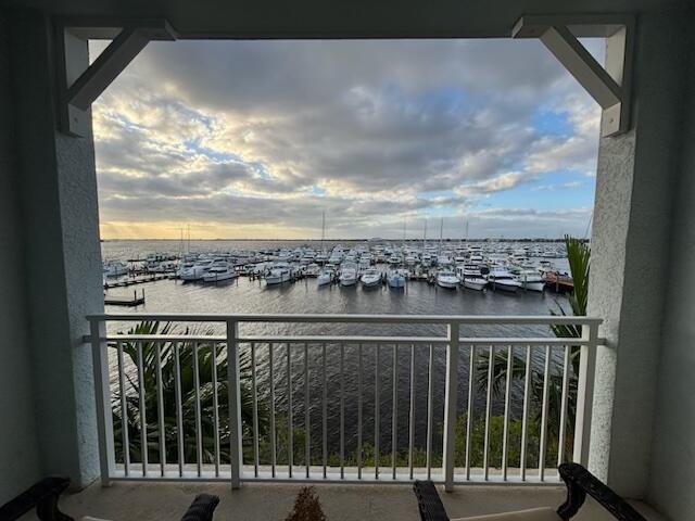 A view of a marina filled with boats from a covered balcony with white railings — 875 NW Flagler Avenue # 302, Stuart FL 34994, STUART, FL